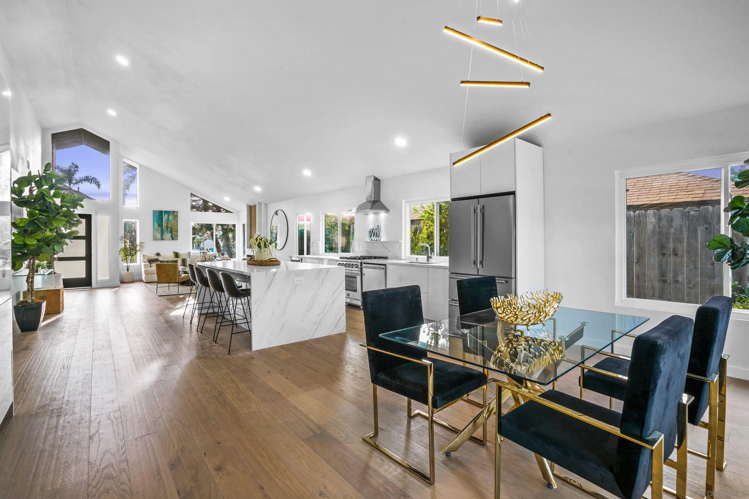 a living room with furniture dining table and a kitchen view