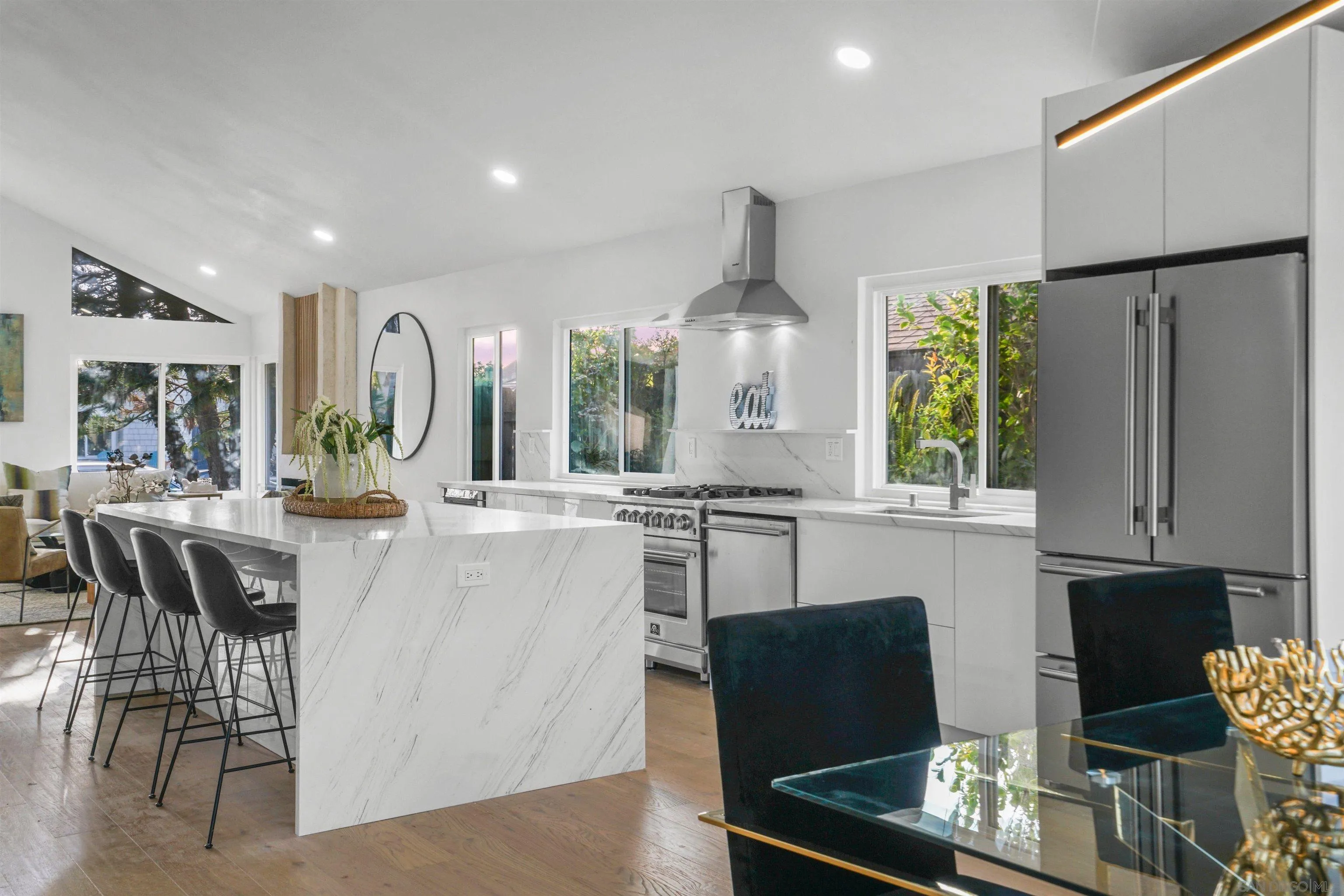 113 Solace Court Encinitas, CA 92024 - Photo 14 of 38 a kitchen with stainless steel appliances granite countertop sink cabinets and wooden floor
