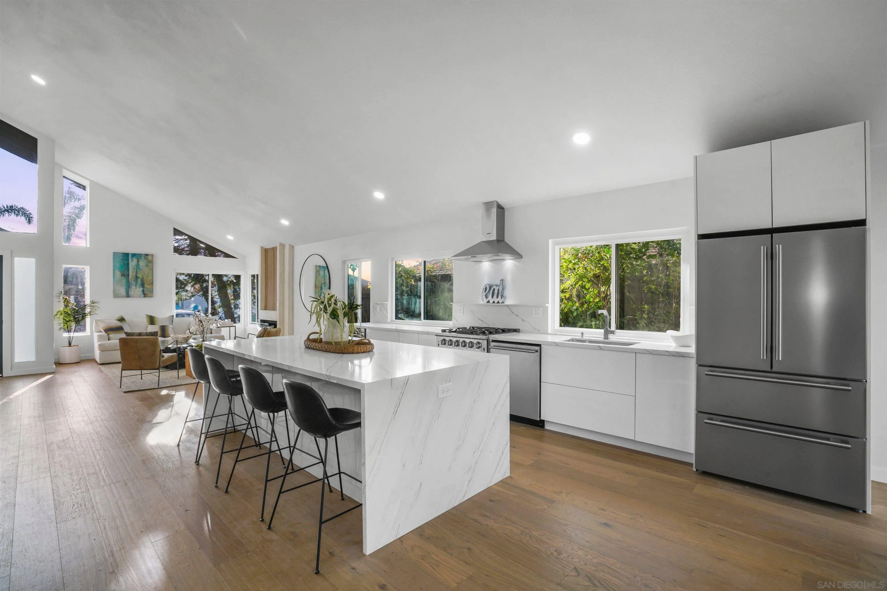 113 Solace Court Encinitas, CA 92024 - Photo 15 of 38 a kitchen with a sink a refrigerator and chairs