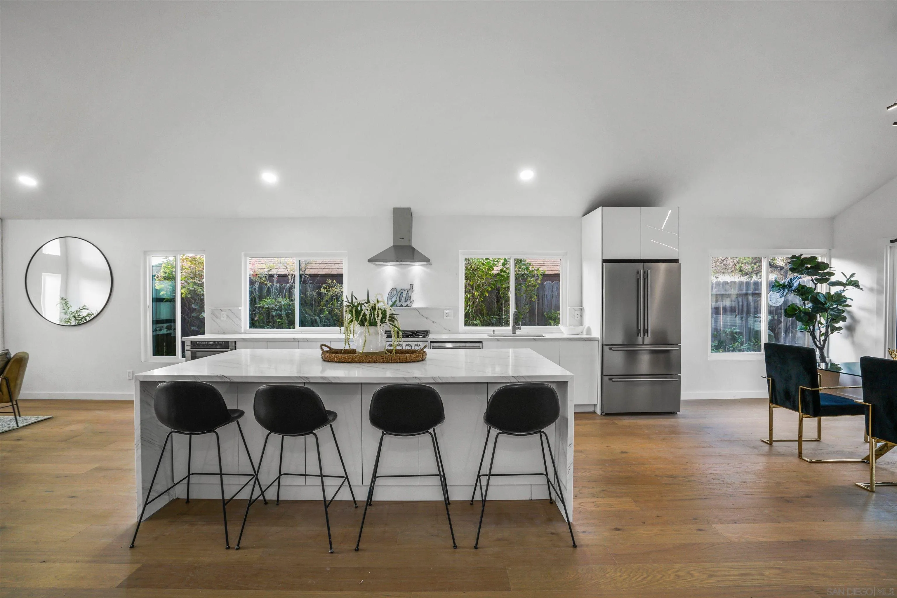 113 Solace Court Encinitas, CA 92024 - Photo 16 of 38 a kitchen with a table chairs and a refrigerator