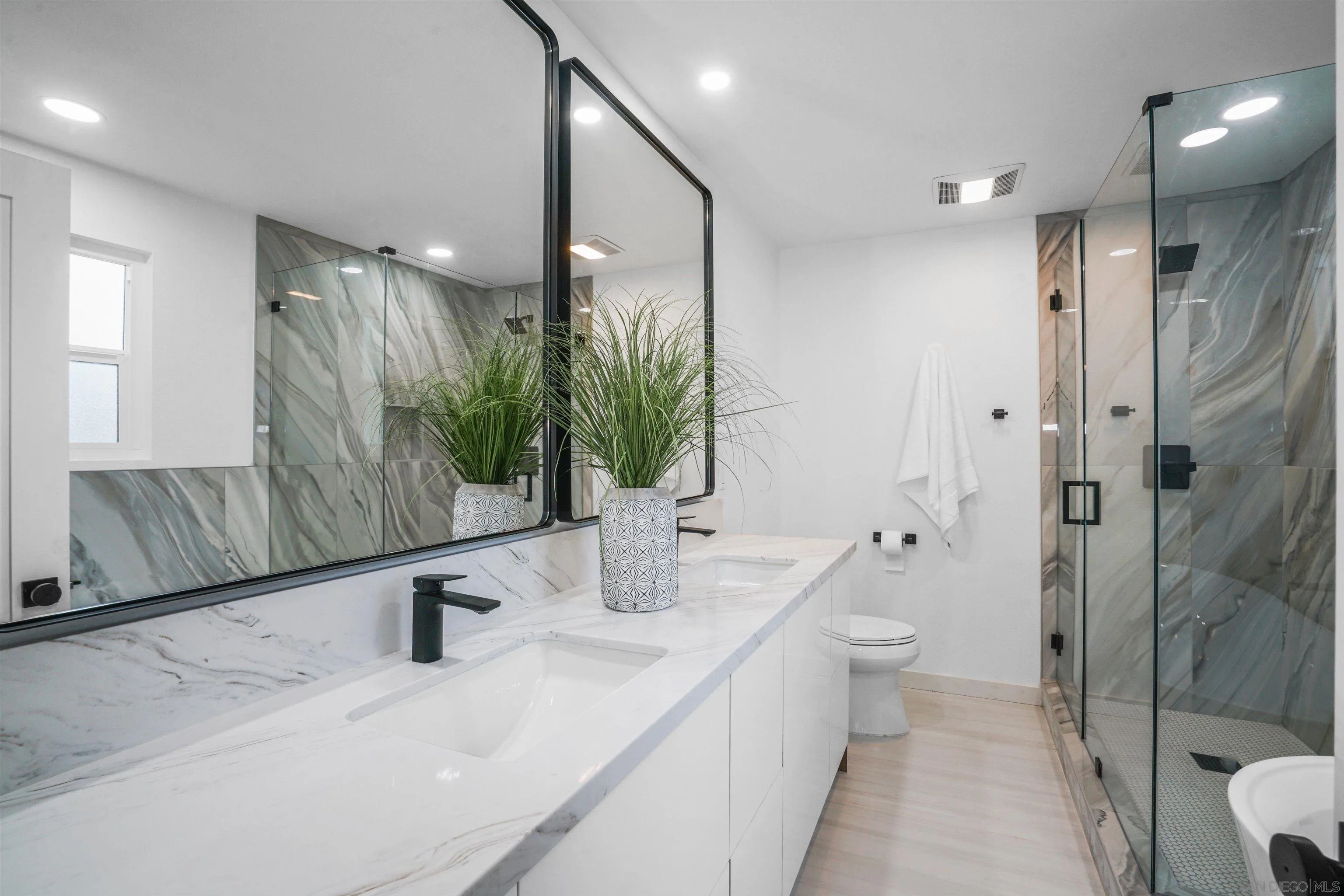 113 Solace Court Encinitas, CA 92024 - Photo 23 of 38 a bathroom with a double vanity sink mirror and toilet