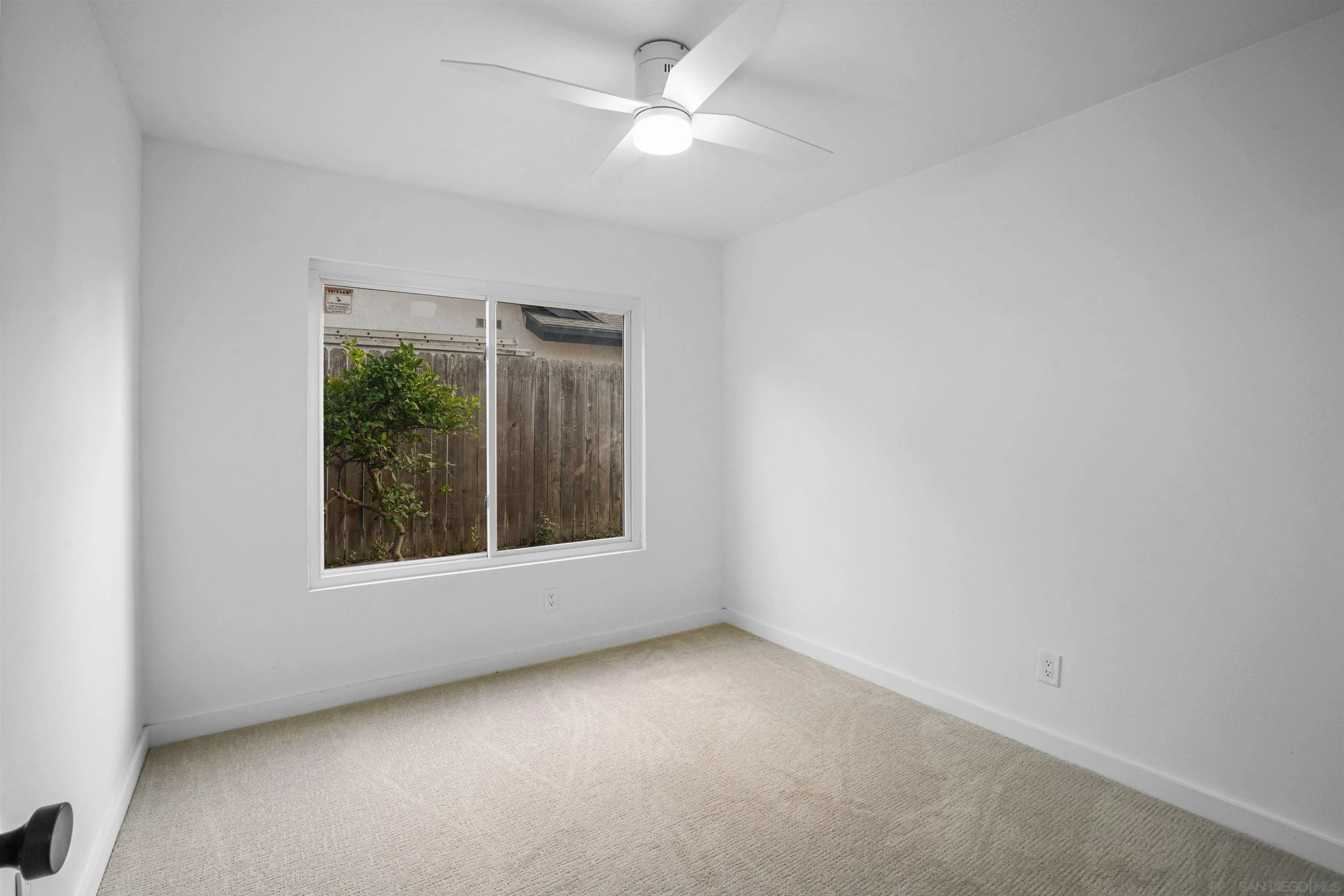 113 Solace Court Encinitas, CA 92024 - Photo 26 of 38 an empty room with a window and a fan