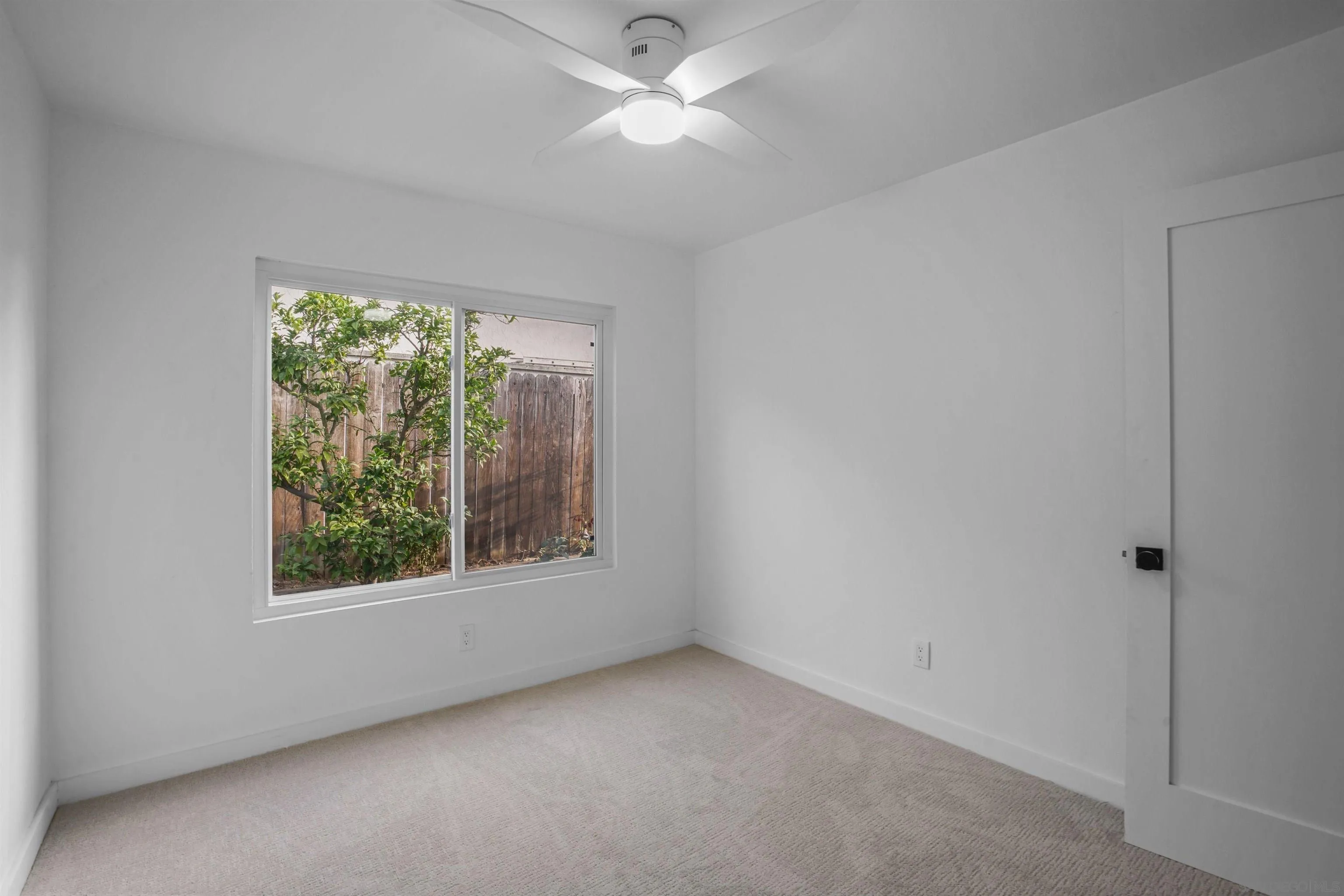 113 Solace Court Encinitas, CA 92024 - Photo 28 of 38 an empty room with a window and a ceiling fan