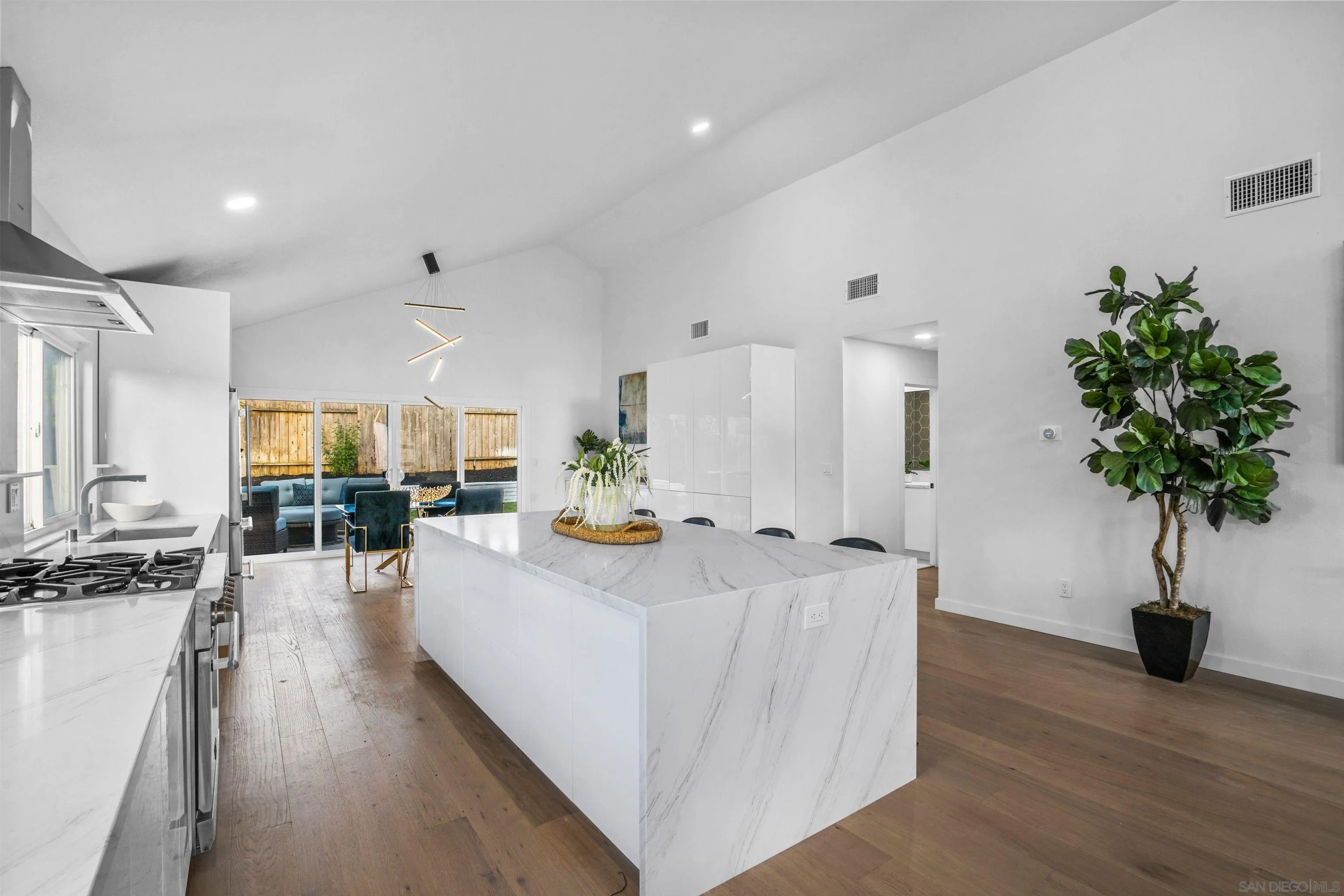 113 Solace Court Encinitas, CA 92024 - Photo 10 of 38 a view of living room kitchen with furniture and wooden floor