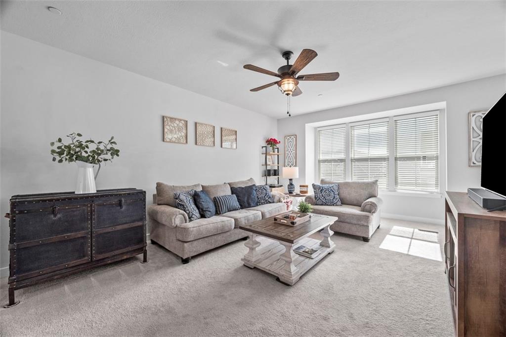309 Helenium Drive Mars, PA 16046 - Photo 9 of 37 Spend time with friends and family in this spacious family room. A ceiling fan/light combo keeps it well lit and allows air to circulate.
