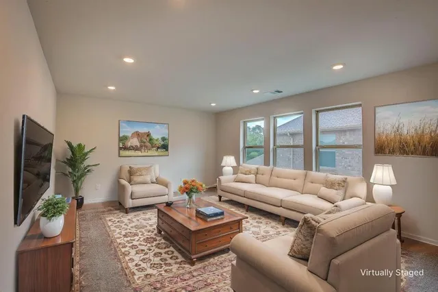 a living room with furniture and a flat screen tv
