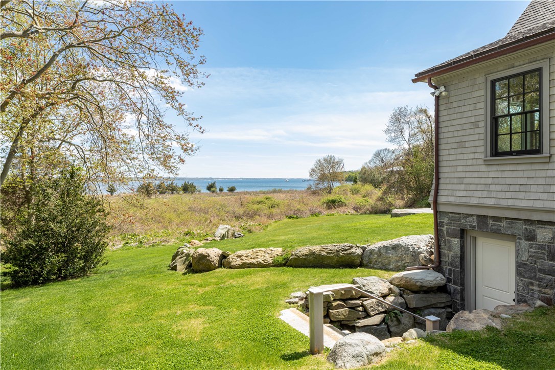 415 Poppasquash Road Bristol, RI 02809 - Photo 43 of 50 Walk-out basement with granite stairs. Full basement offers a wonderful opportunity to create additional living space.