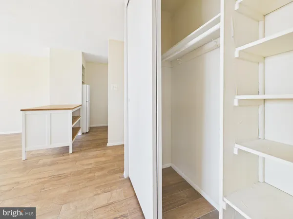 a view of hallway with stairs and wooden floor