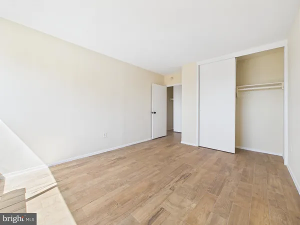 a view of a room with wooden floor and a sink