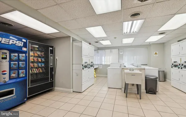 a large room with lots of furniture and chandelier