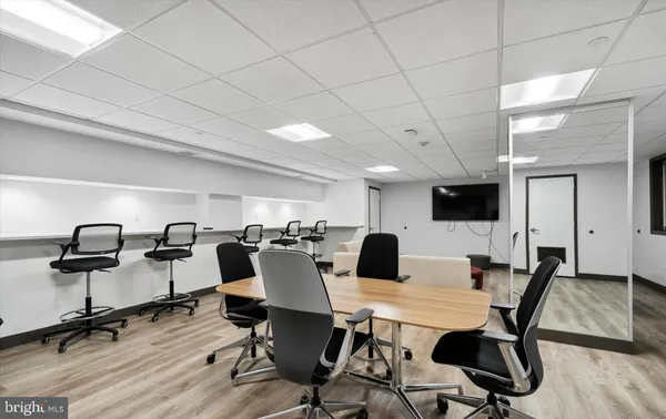 a view of a dining room with a table and chairs