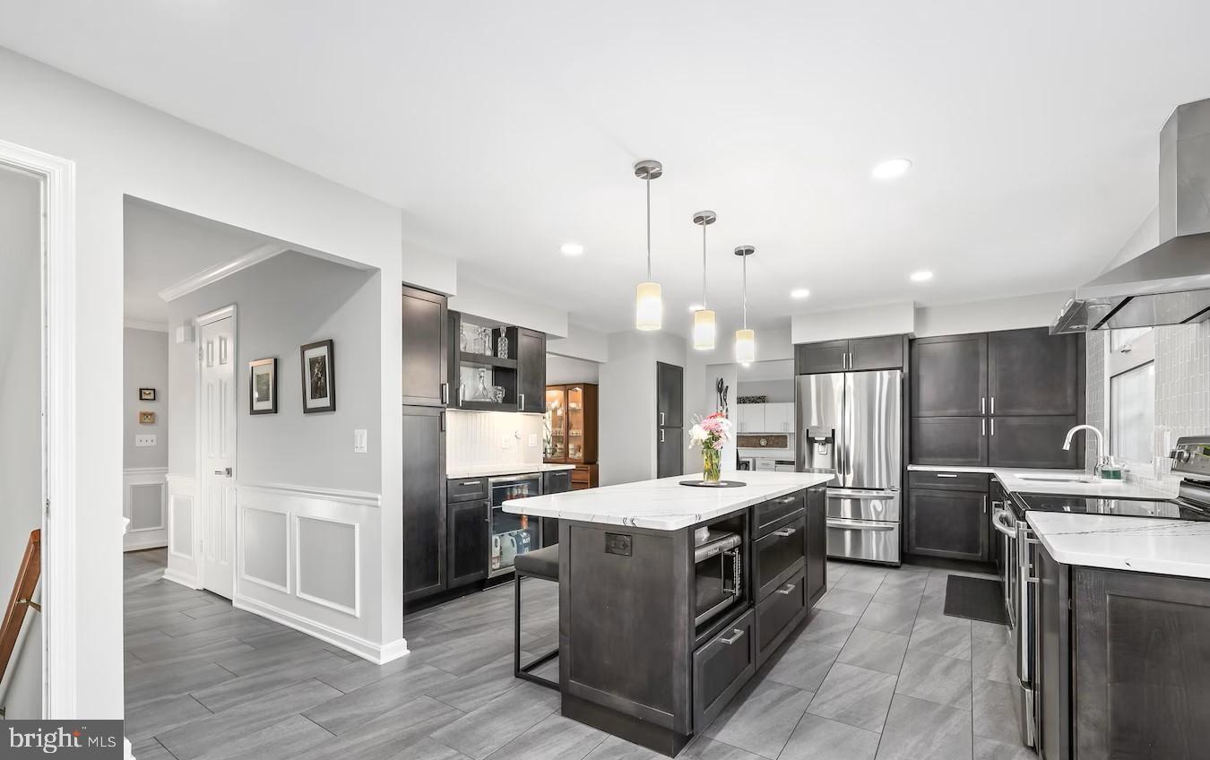 18505 Cabin Road Triangle, VA 22172 - Photo 10 of 40 a large kitchen with a large counter top a sink stainless steel appliances and cabinets