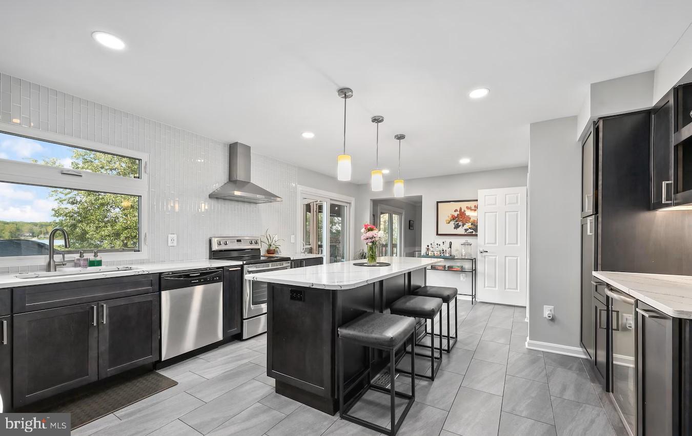 18505 Cabin Road Triangle, VA 22172 - Photo 11 of 40 a large kitchen with cabinets chairs and refrigerator