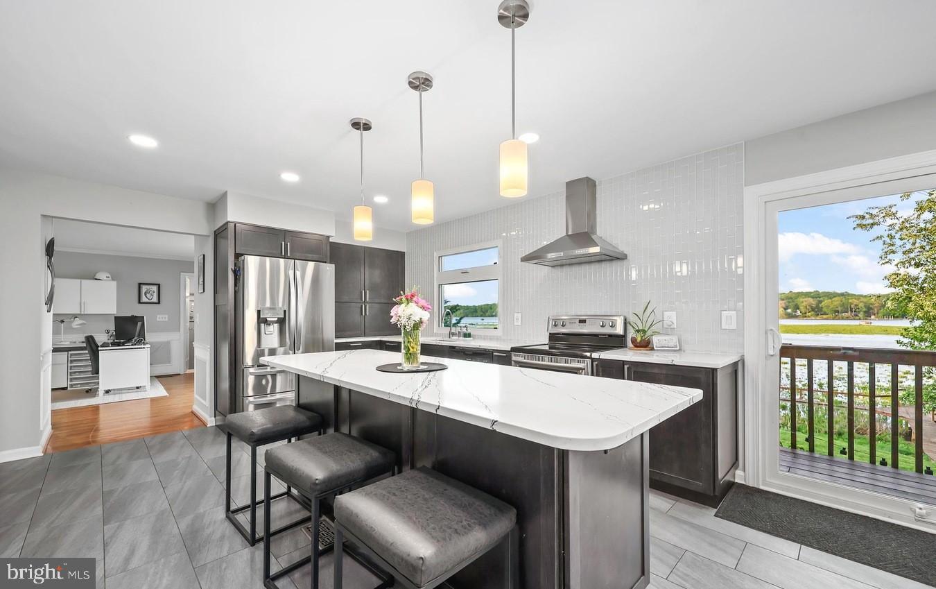18505 Cabin Road Triangle, VA 22172 - Photo 13 of 40 a kitchen with a stove a sink a counter top space and a center island