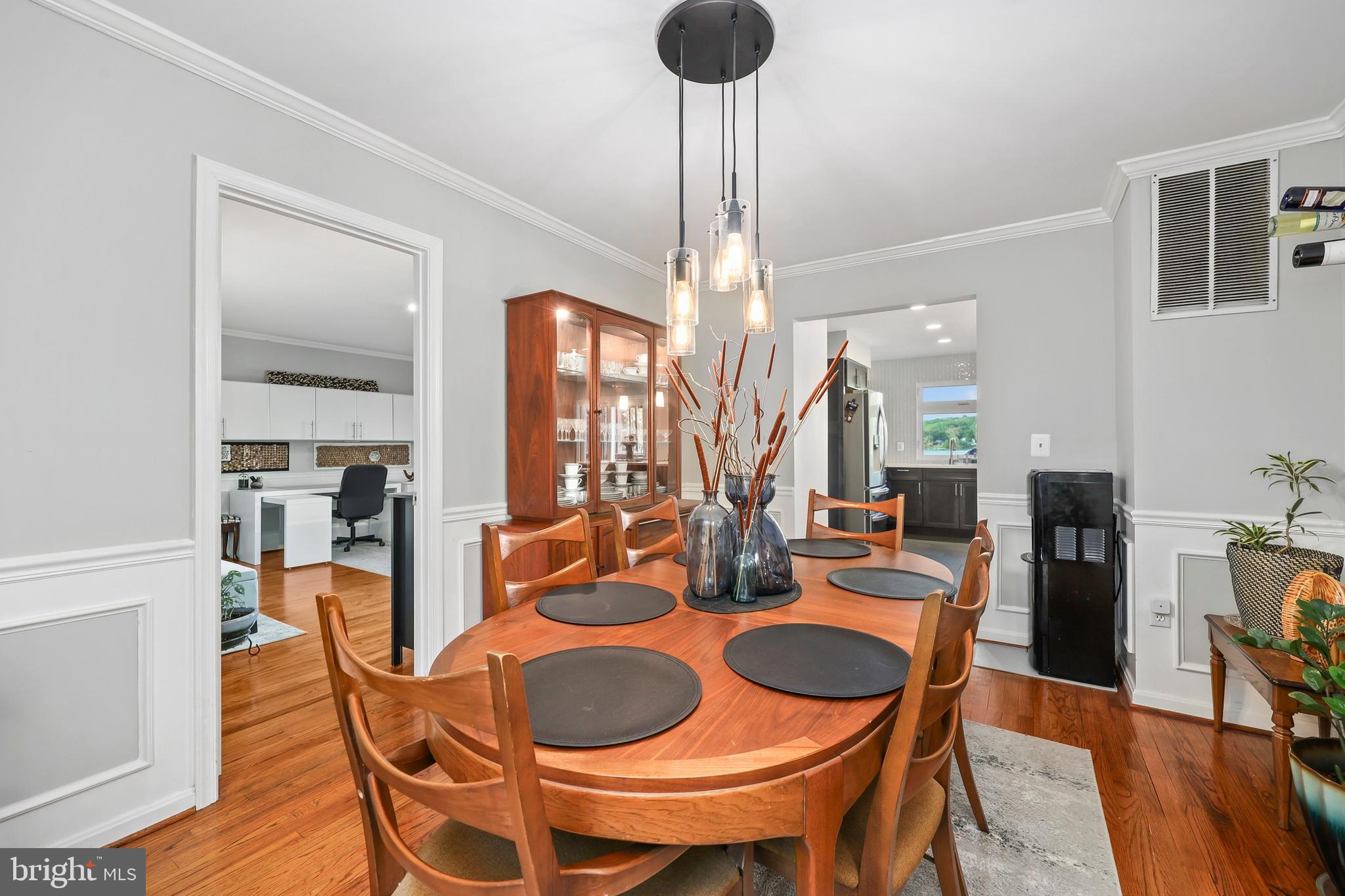 18505 Cabin Road Triangle, VA 22172 - Photo 14 of 40 a dining room with furniture a chandelier and wooden floor