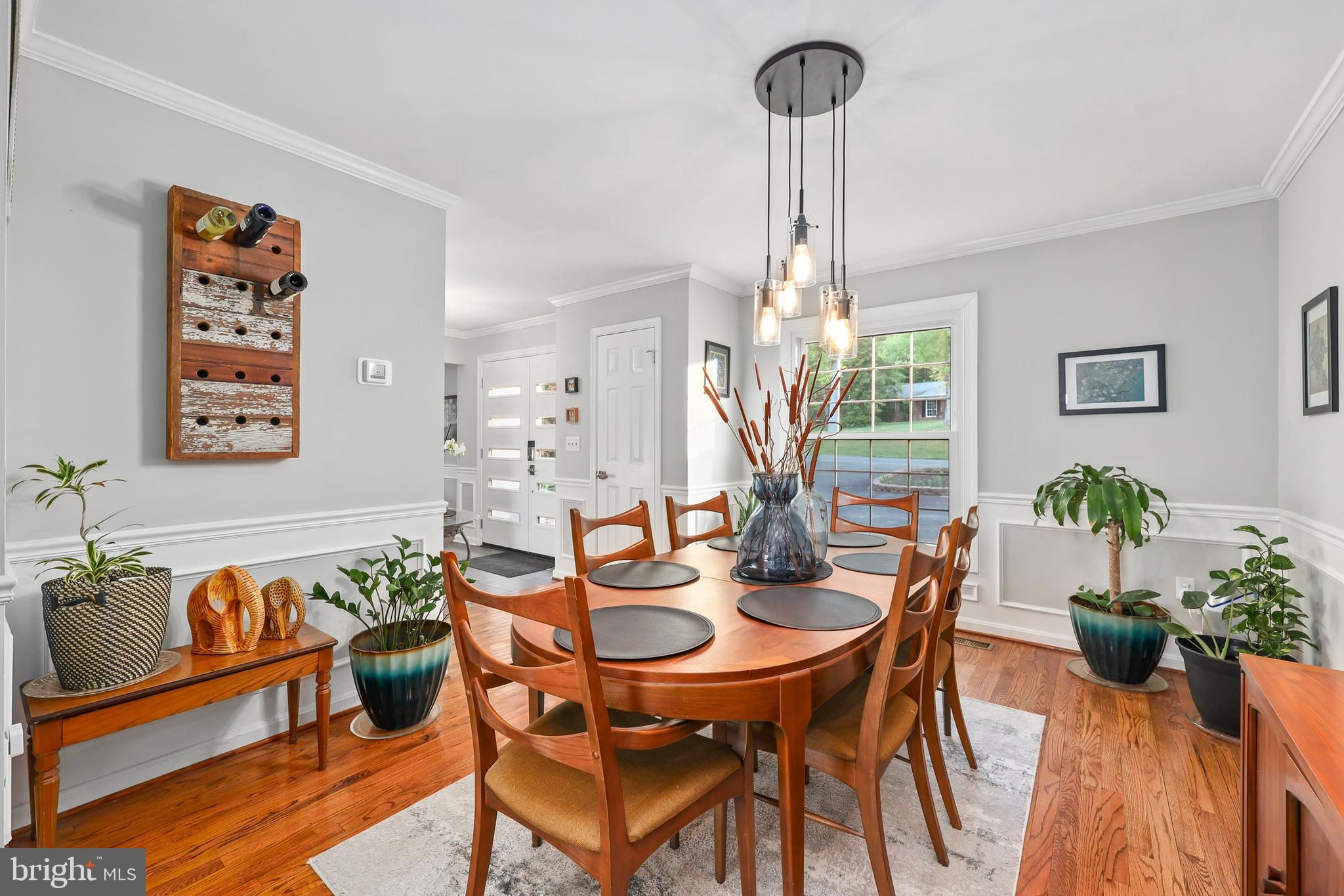 18505 Cabin Road Triangle, VA 22172 - Photo 15 of 40 a view of a dining room and livingroom with furniture wooden floor a chandelier