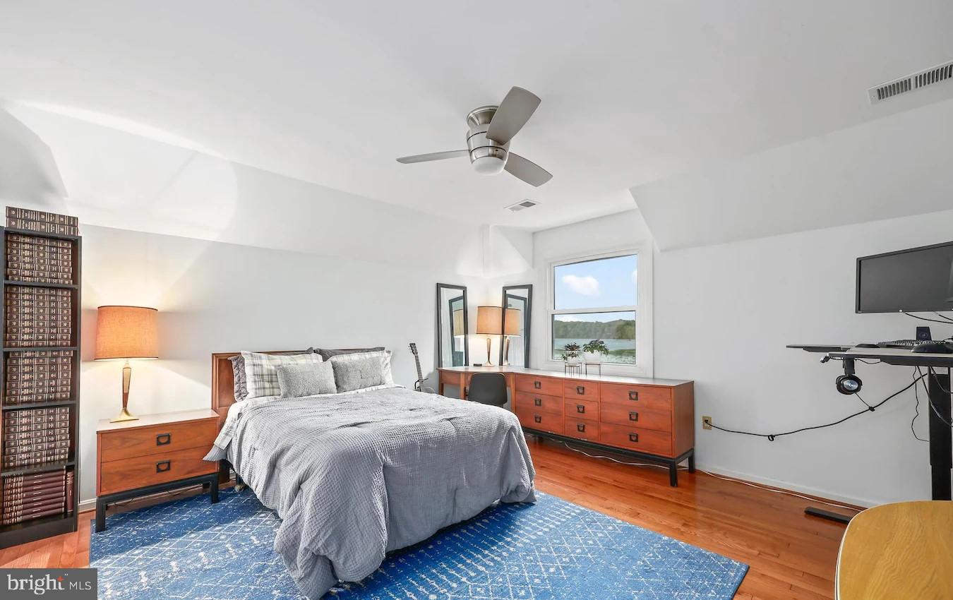 18505 Cabin Road Triangle, VA 22172 - Photo 22 of 40 a bedroom with a large bed and wooden floor