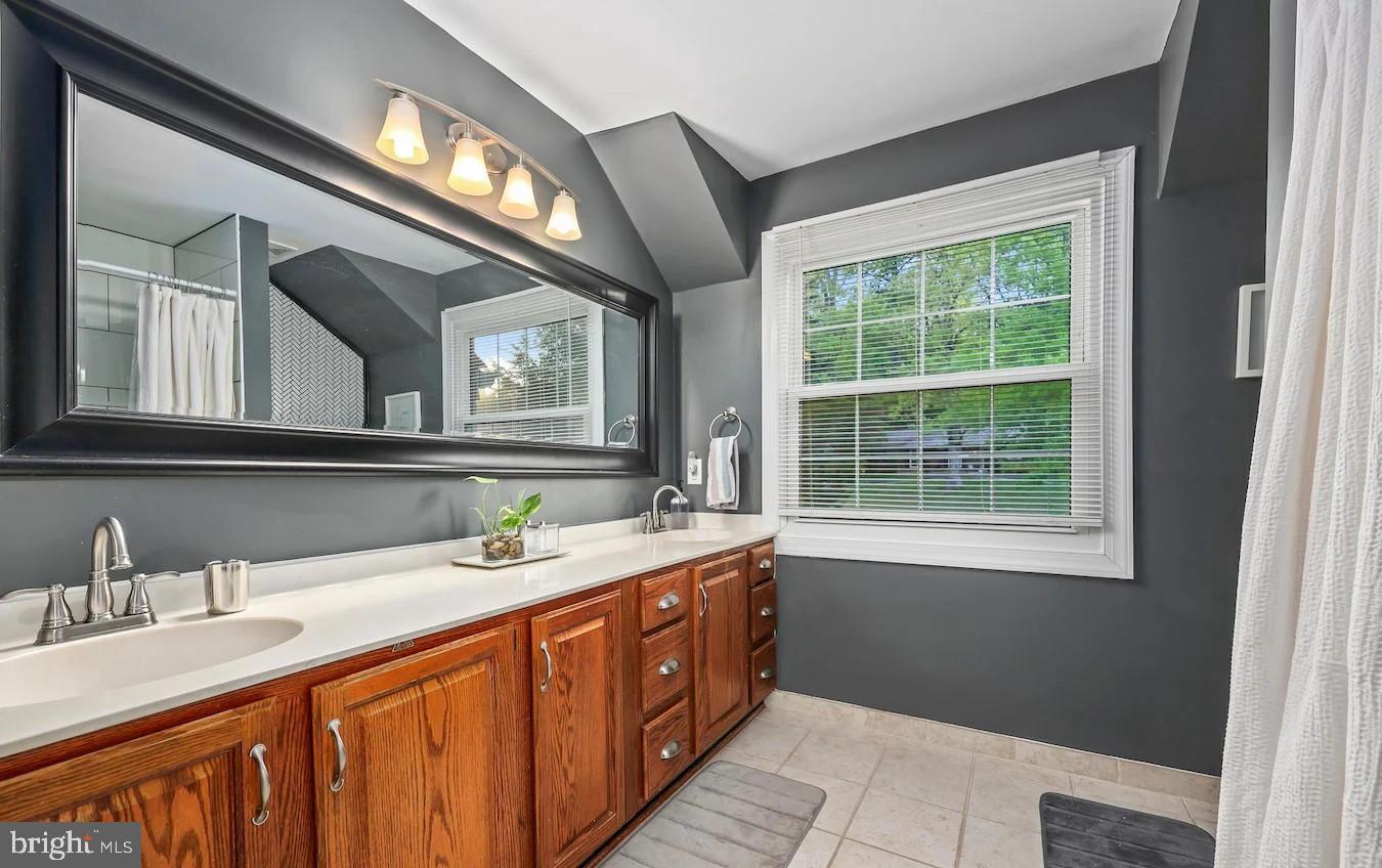 18505 Cabin Road Triangle, VA 22172 - Photo 25 of 40 a bathroom with a double vanity sink and a mirror