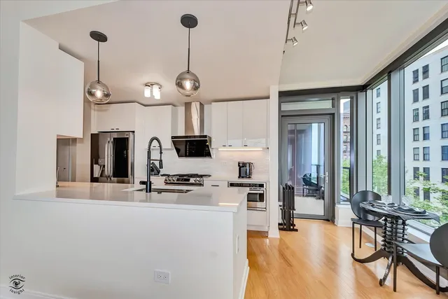 a view of a kitchen with microwave and furniture