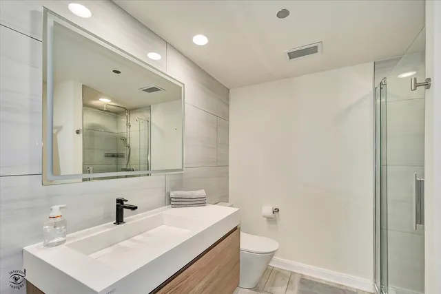 a bathroom with a glass shower door