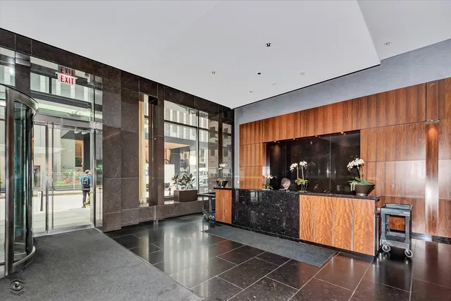 a dining room with furniture and a large window