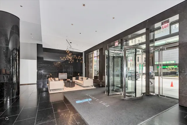 a living room with furniture and a floor to ceiling window