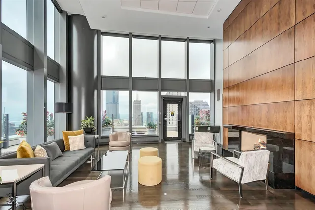 a living room with furniture a flat screen tv and a large window