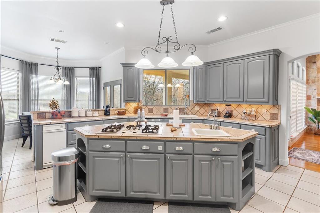 117 Redtail Court Weatherford, TX 76088 - Photo 14 of 39 a kitchen with a sink stove and cabinets