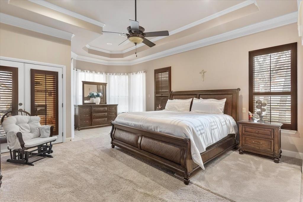 117 Redtail Court Weatherford, TX 76088 - Photo 21 of 39 a bedroom with a bed a chair and large windows