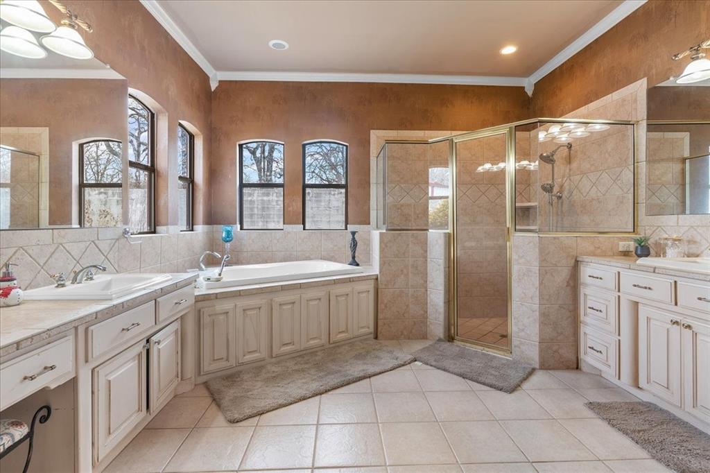 117 Redtail Court Weatherford, TX 76088 - Photo 25 of 39 a spacious bathroom with a double vanity sink mirror and shower
