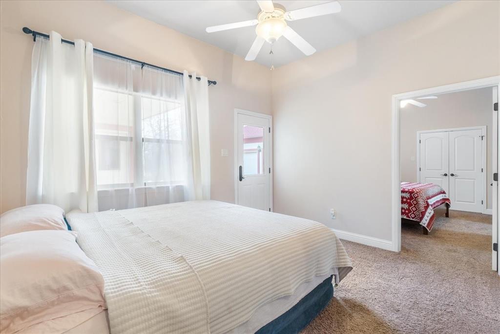 117 Redtail Court Weatherford, TX 76088 - Photo 27 of 39 a bedroom with a bed and a chandelier