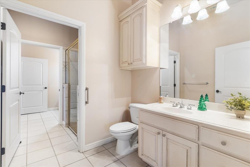 117 Redtail Court Weatherford, TX 76088 - Photo 30 of 39 a spacious bathroom with a granite countertop sink a toilet and a mirror