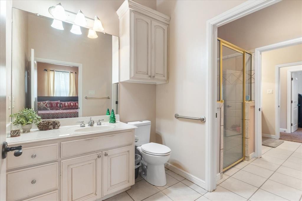 117 Redtail Court Weatherford, TX 76088 - Photo 31 of 39 a bathroom with a double vanity sink mirror and toilet
