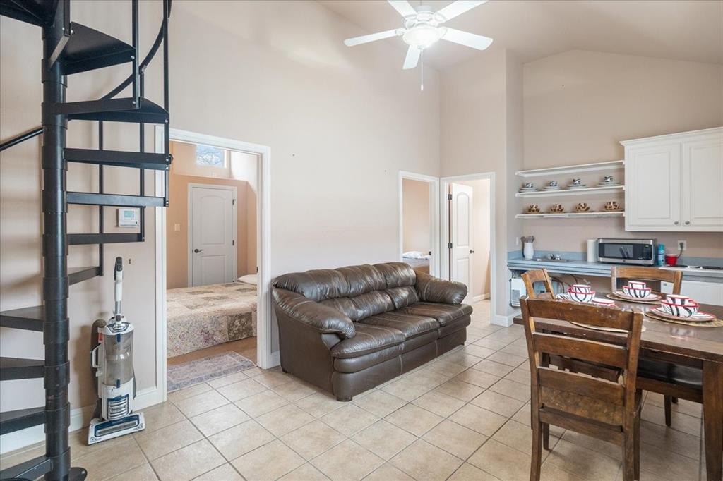 117 Redtail Court Weatherford, TX 76088 - Photo 32 of 39 a living room with furniture and a kitchen view