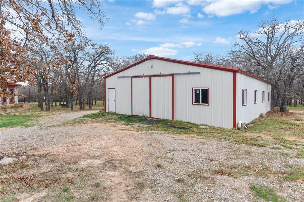 117 Redtail Court Weatherford, TX 76088 - Photo 34 of 39 a view of a large white house next to a yard with large trees