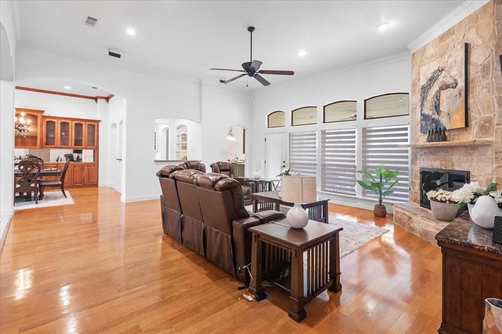 117 Redtail Court Weatherford, TX 76088 - Photo 9 of 39 a living room with fireplace furniture and a wooden floor