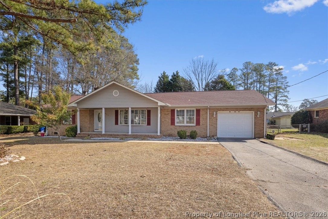 630 Bedford Road Fayetteville, NC 28303 - Photo 1 of 21 a front view of a house with a yard and garage