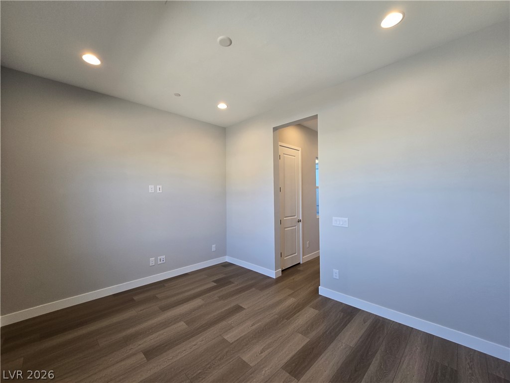 852 Weston Ridge Street Henderson, NV 89011 - Photo 24 of 28 Recessed lighting illuminates this versatile room, featuring rich hardwood flooring.