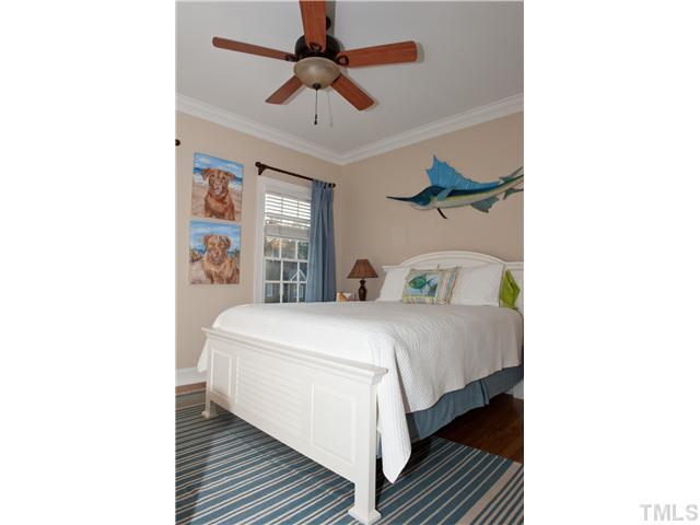 5801 Orchid Valley Road Raleigh, NC 27613 - Photo 11 of 25 a bedroom with a bed and a chandelier