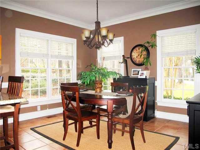 5801 Orchid Valley Road Raleigh, NC 27613 - Photo 9 of 25 a dining room with furniture a large clock and a large window