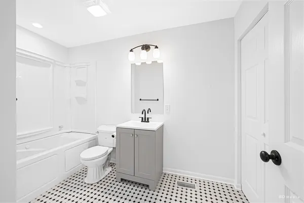 a bathroom with a toilet a sink and a bathtub