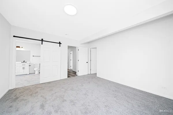 a view of a big room with closet and a chandelier fan