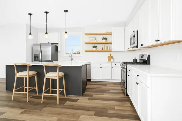 a kitchen with cabinets a sink and appliances