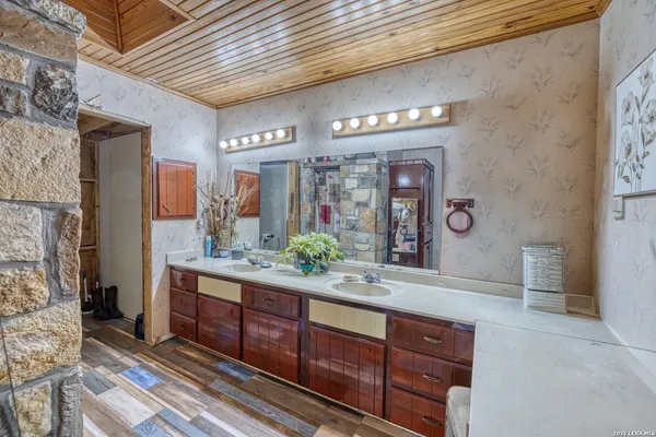a bathroom with double vanity sink and a mirror