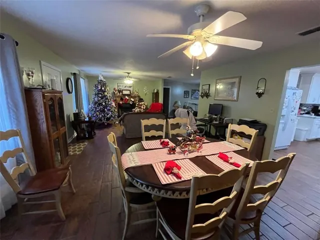 a view of a dining room with furniture and chandelier