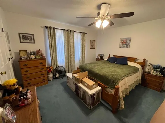 a bedroom with bed and a chandelier