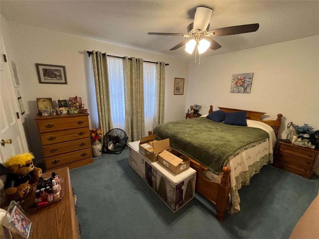 33 East Kenora Drive Southwest Rome, GA 30165 - Photo 17 of 30 a bedroom with bed and a chandelier