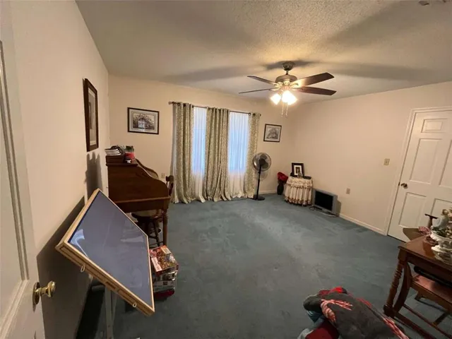 a room with gym equipment and view of living room