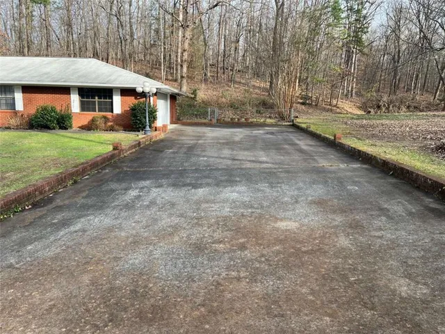 a view of a house with a yard and garage