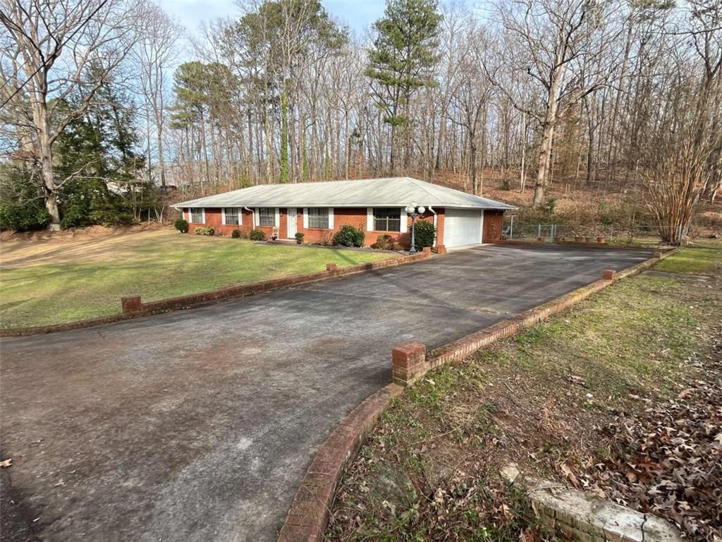 33 East Kenora Drive Southwest Rome, GA 30165 - Photo 26 of 30 a view of a house with backyard and trees